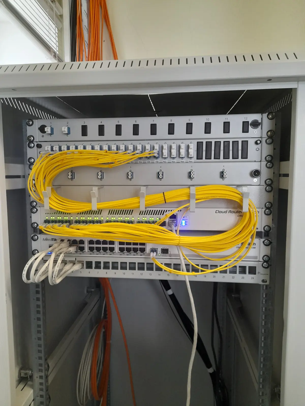 Sauber aufgelegte Glasfaseranschlüsse in einem Netzwerkschrank